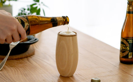 竹製タンブラーにビールを注いでいる画像